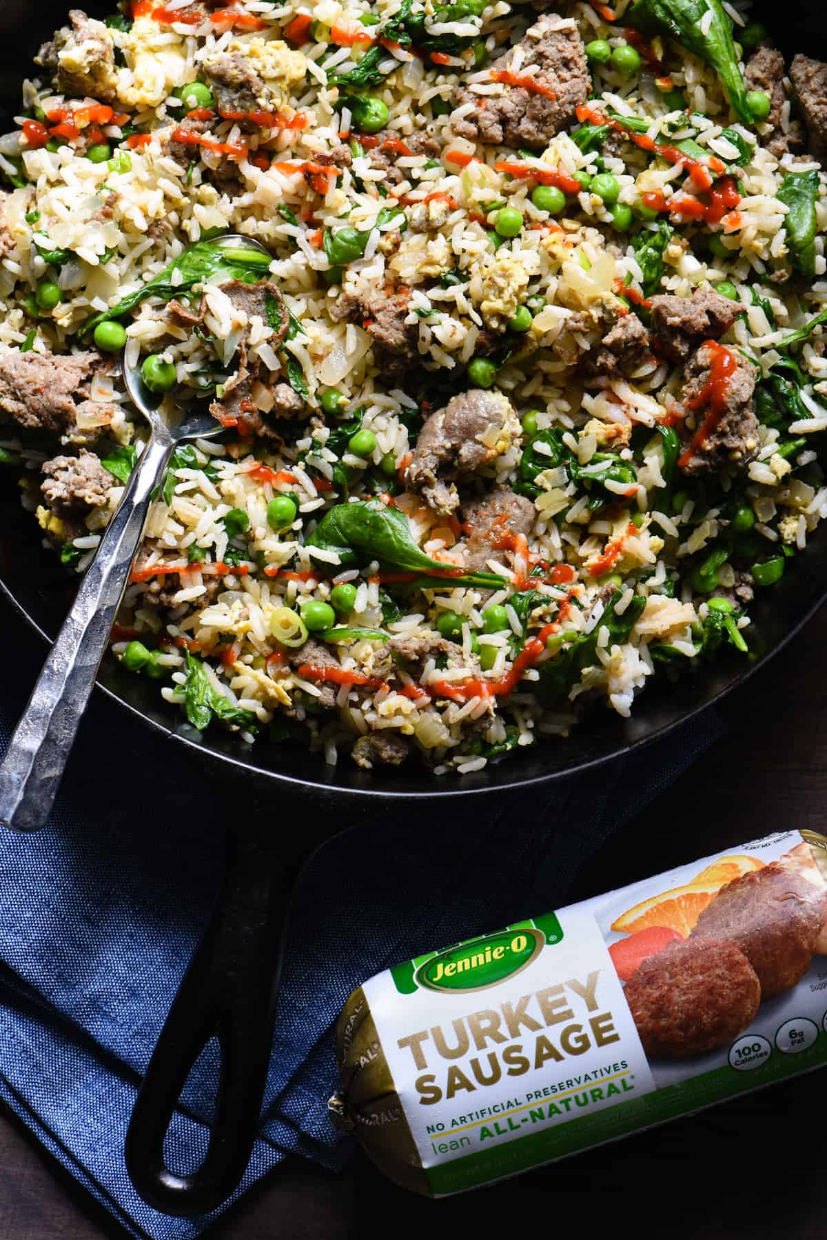 Break out a big cast iron skillet and feed a crowd with this Breakfast Fried Rice. Full of lean turkey sausage, eggs and lots of veggies, this will keep the crew fueled all morning. | foxeslovelemons.com Cast iron skilled filled with sausage fried rice, topped with avocado slices.
