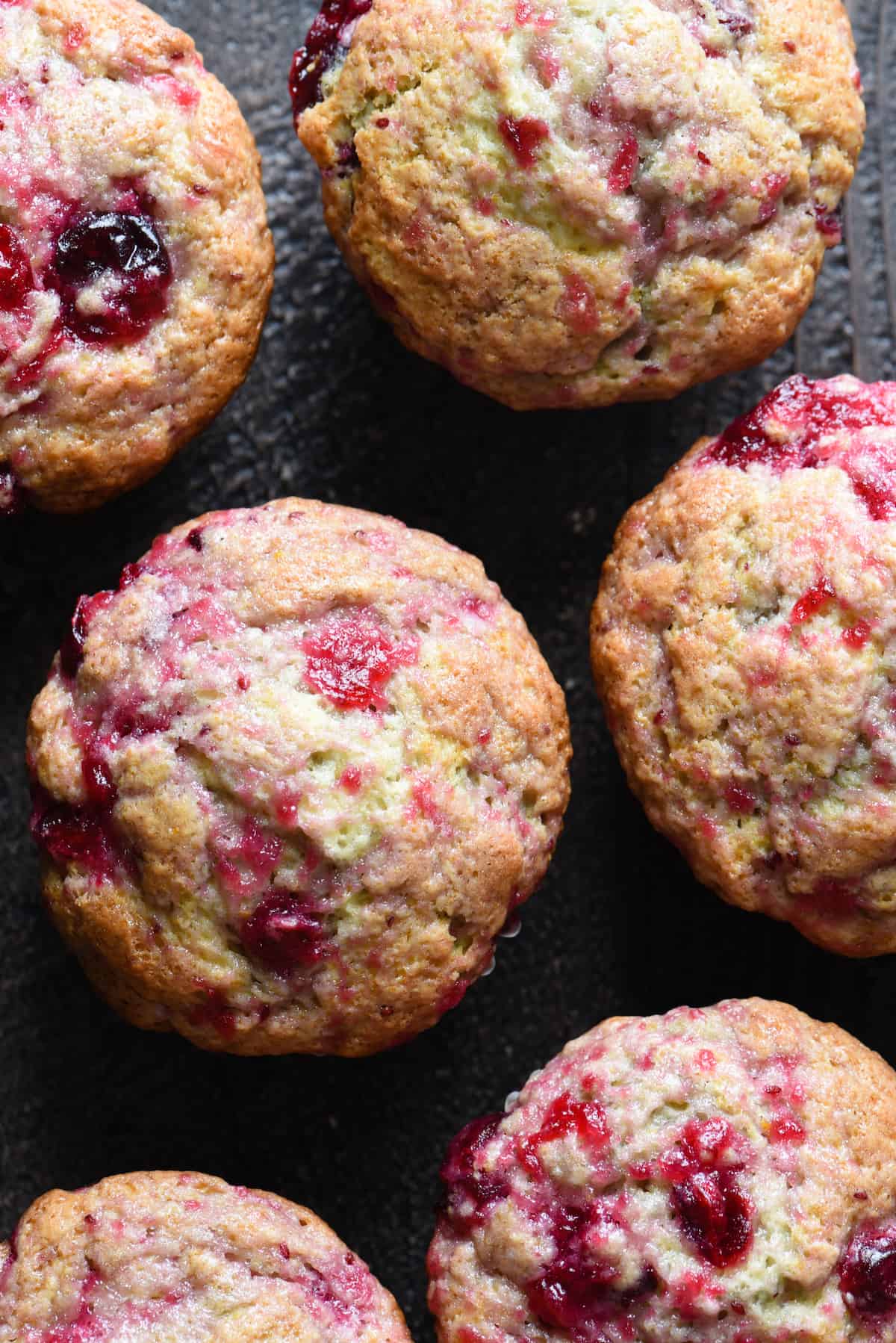 These Cranberry Sauce Muffins are the most delicious way to use up leftover cranberry sauce after Thanksgiving. You can whip these up in just a few minutes! | foxeslovelemons.com Overhead photo of six cranberry sauce muffins.