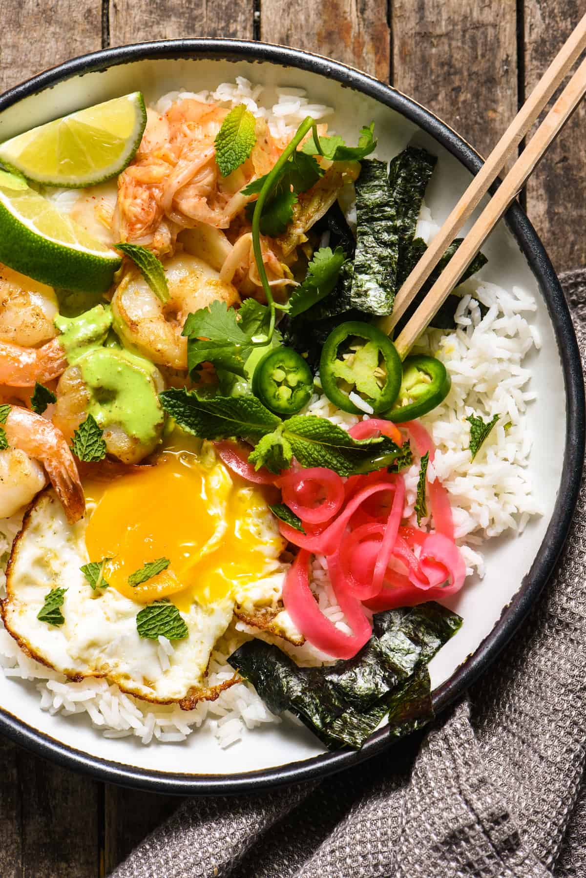 Funky Good Rice & Shrimp Bowls - Shake up your weeknight dinner routine with a rice bowl loaded with shrimp, pickled veggies and a fried egg, and topped with an easy homemade green chili sauce. | foxeslovelemons.com