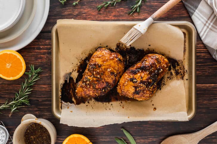 The best turkey tenderloin recipe being basted with a brush.