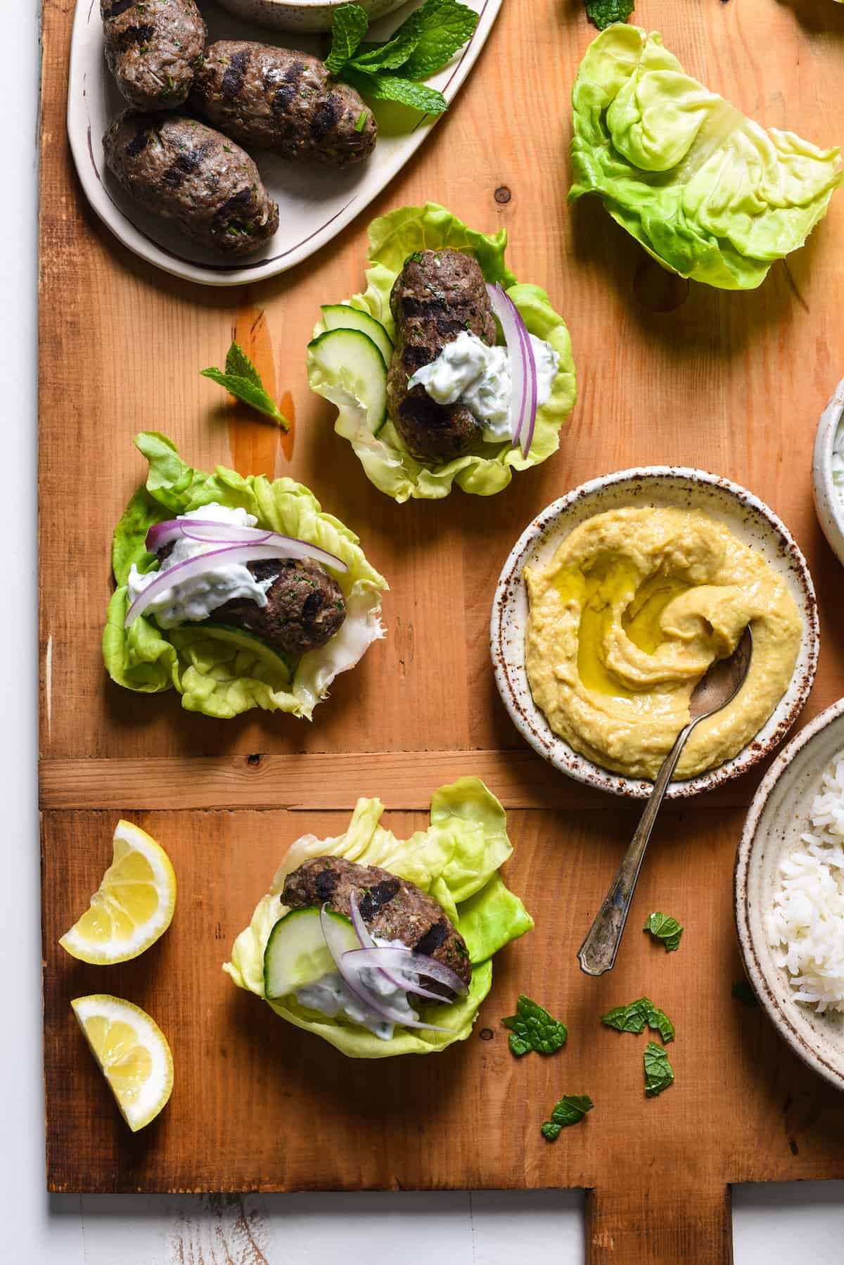 Grilled Kafta Lettuce Wraps - Spiced lamb and beef patties are wrapped in cooling butter lettuce leaves for a fresh and flavorful meal you'll want to serve every week! | foxeslovelemons.com