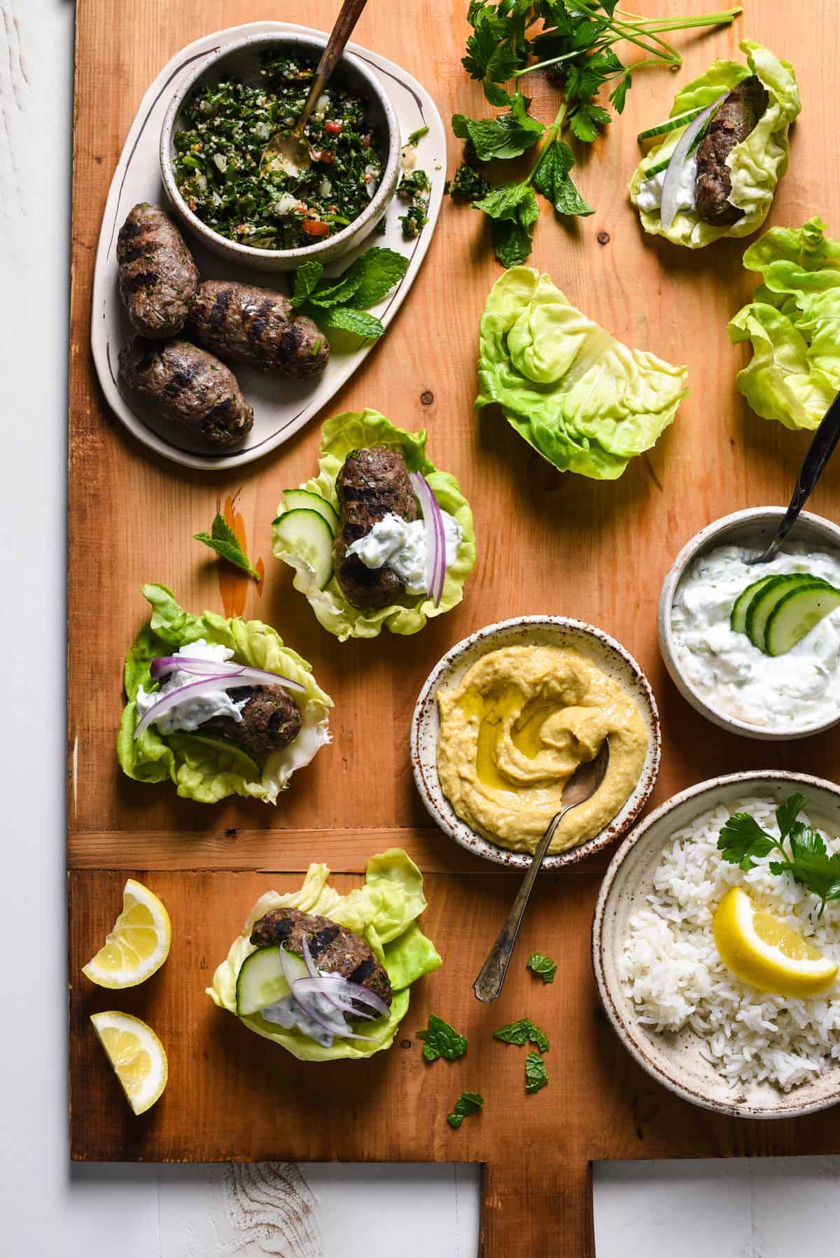 Grilled Kafta Lettuce Wraps - Spiced lamb and beef patties are wrapped in cooling butter lettuce leaves for a fresh and flavorful meal you'll want to serve every week! | foxeslovelemons.com