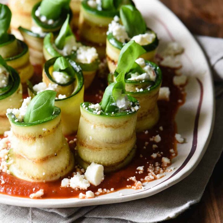 Use your grill to prepare these easy but elegant Grilled Zucchini Roll Ups with Feta. Serve as a party appetizer, a vegetable side dish, or even a light summer meal. | foxeslovelemons.com