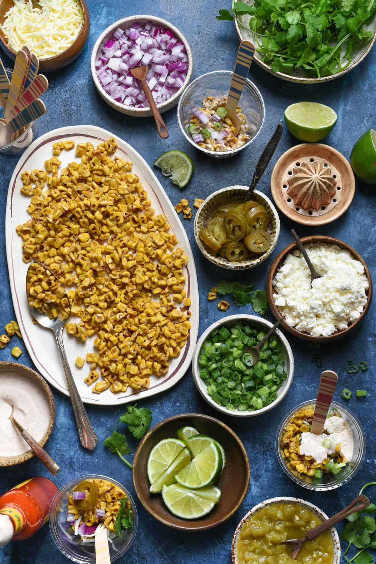 Having a fiesta? Please the whole crowd with this Mexican Street Corn Salad Bar. Gather all of the ingredients for classic Mexican street corn (elote), but let everybody assemble their own. Perfect for the spice lovers, the picky eaters, and the cilantro-adverse! | foxeslovelemons.com Having a fiesta? Please the whole crowd with this Mexican Street Corn Salad Bar. Gather all of the ingredients for classic Mexican street corn (elote), but let everybody assemble their own. Perfect for the spice lovers, the picky eaters, and the cilantro-adverse! | foxeslovelemons.com