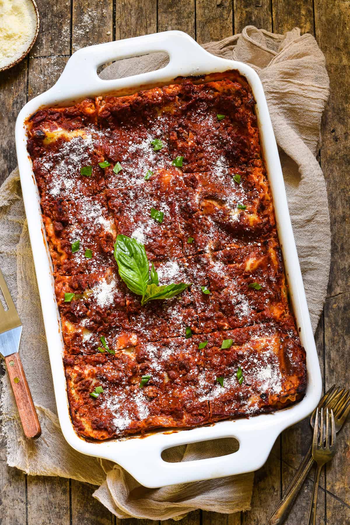 Lasagna with Cottage Cheese - A classic Midwestern noodle casserole. Layers of rich meat sauce, pasta, creamy filling and cheese will have the whole family coming back for seconds! | foxeslovelemons.com Overhead photo of a large rectangular white casserole dish filled with cottage cheese lasagna.