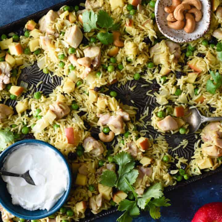 This easy Sheet Pan Chicken & Apple Curry is a complete meal on a pan, and will fill your family up with chicken, rice, fruits and vegetables. Everything goes onto a single baking pan! | foxeslovelemons.com
