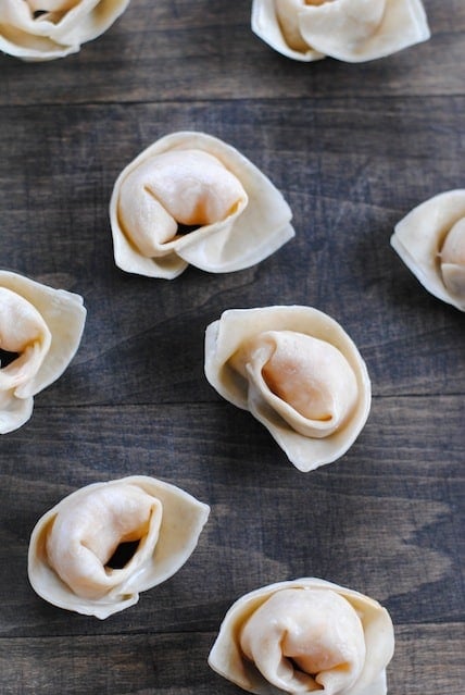 Small Chinese dumplings on a wooden tabletop.